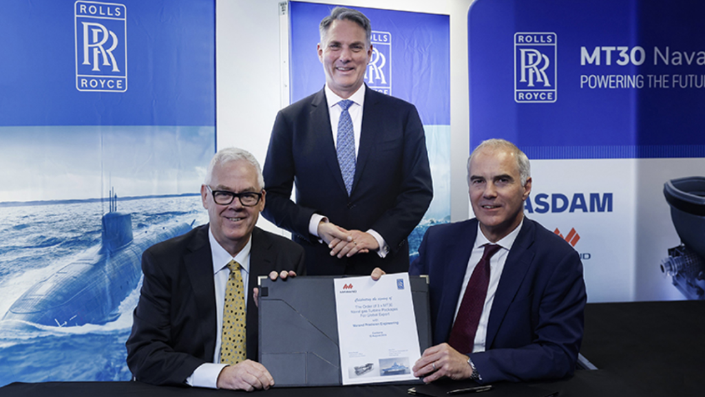 Rohan Stocker, CEO of ASDAM Group and Marand; and Alex Zino, Defence Director of Business Development and Future Programmes, UK and International, Rolls-Royce; participate in a formal signing ceremony in the presence of Deputy Prime Minister and Minister for Defence, the Hon Richard Marles MP